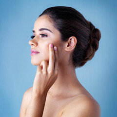 Profile, skincare and woman with beauty, thinking and dermatology on blue studio background....