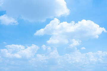 A bright blue sky filled with fluffy white clouds on a sunny day
