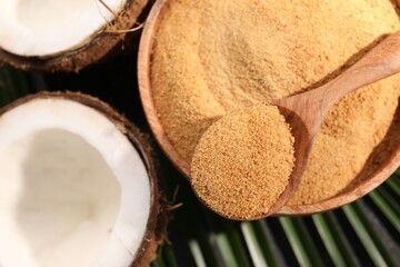 Spoon with coconut sugar, bowl and fruits on table, flat lay