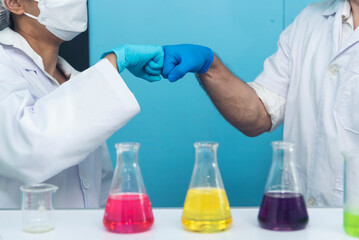 Two caucasian scientist men woman fist bump team partner shake hands together. Teamwork two...