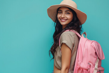 young indian woman standing with backpack on blue background