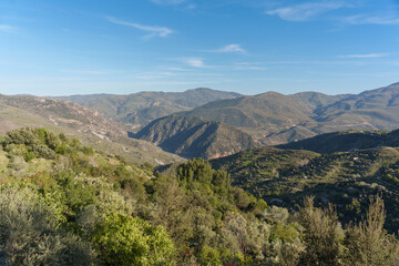 view of the mountains, nature, and the valley, on a day with almost clear skies
