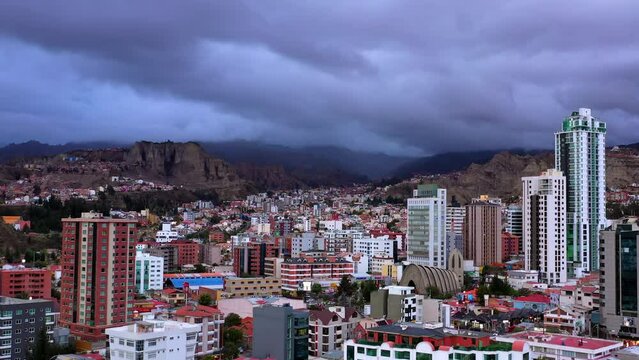 Aerial Scenic View Of Residential City By Mountains Under Cloudy Sky, Drone Flying Forward On Sunny Day - La Paz, Bolivia