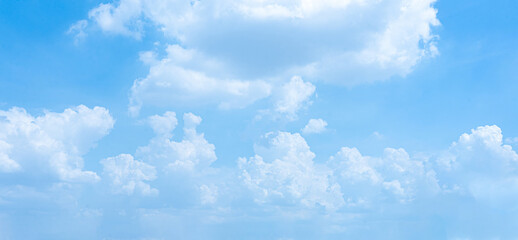 A bright blue sky filled with fluffy white clouds on a sunny day