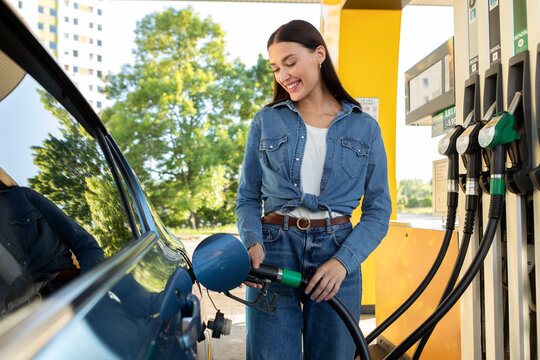 Woman refilling auto with bio fuel at modern petrol station. Eco friendly and convenient car care, automobile fueling offer concept