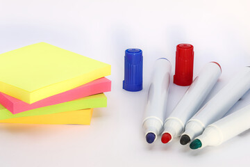 office supplies markers and sticky notes on a white background