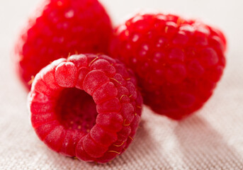 Three raspberry berries on white background