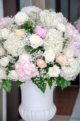 Details of an artistic plaster vase with fresh flowers.  Floral arrangement for the event.