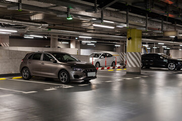 Single luxury car in parking lot in an underground parking garage, free copy space
