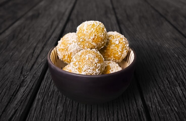Baked ice cream with coconut flakes in a bowl. Close-up