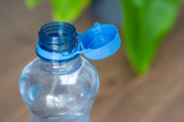 Stationary plastic cap on a PET bottle. The new design means the cap remains attached to the bottle...