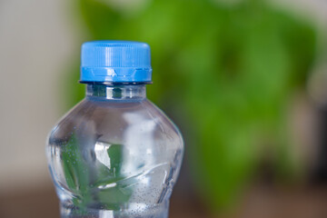 Stationary plastic cap on a PET bottle. The new design means the cap remains attached to the bottle after opening, making the entire package easier to collect and recycle