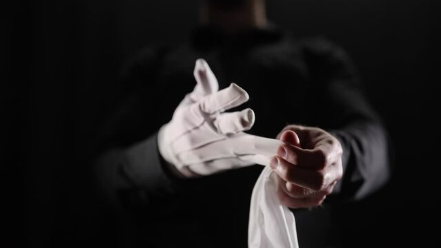 Headless mystery person remove and drop the white gloves close-up 4K