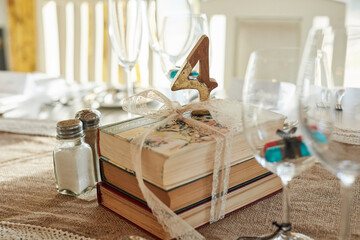 Wedding decor, table and vintage ceremony for event, reception and books for style at venue. Party,...