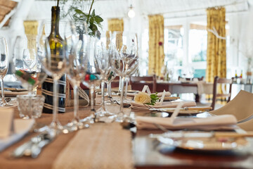 Wedding decor, table and vintage ceremony for reception, plate and napkin for style at venue. Party, unique restaurant and empty room for dinner, wine glasses and rustic aesthetic for celebration