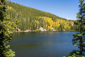 Bear Lake in Rocky Mountain National Park near Estes Park, Colorado on a sunny fall day. The yellow aspens color the mountainside.