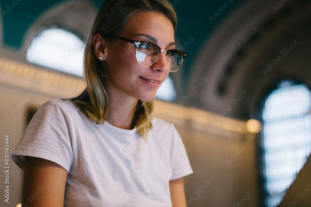 Aufkleber positive clever hipster girl searching information on education websites using laptop computer and w