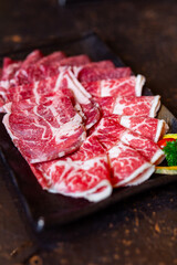 Wagyu beef , august oyster beef , august chuck sliced on rectangle black plate in a grill restaurant