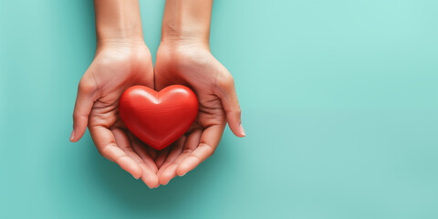 Obraz premium top view of hands holding red heart