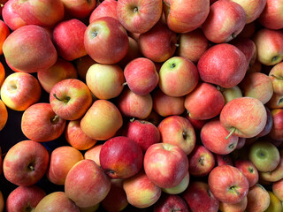 Pile of red apples as background, texture. Healthy eating. Full frame shot of red apples. Fresh apples from the market. Ripped raw red apples group, view from above.