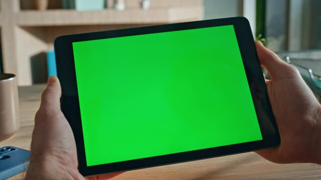 Closeup hands holding mockup tablet in office close up. Unknown businessman