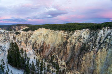 A pink and blue sunset over the Grand Canyon of the Yellowstone in Yellowstone National Park in Wyoming