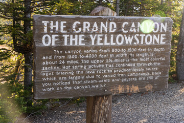 Fototapeta premium Sign and info for the Grand Canyon of the Yellowstone at Canyon Village in Yellowstone National Park in Wyoming on a sunny morning