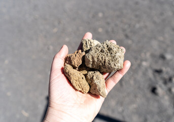 Volcano Stones in Hand, Volcanic Pumice with Glass, Pieces of Lava, Basalt Extrusive Igneous Rock