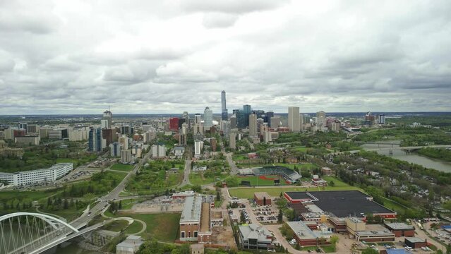 Edmonton downtown skyline with perspective over the Queen Elizabeth II Park, with the Walterdale Bridge featured. The vibrant cityscape, nestled along the North Saskatchewan River.