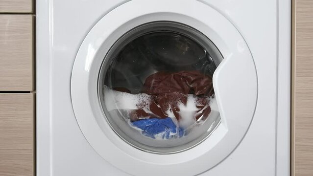 Close-up of a built-in washing machine in a home kitchen.