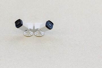 Two external city CCTV security cameras on the wall of the house. Safe and comfortable urban environment. Crime control and prevention. Street security, security. Improving the quality of city life.