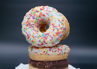 Donuts with icing and colored sprinkles. Close-up confectionery