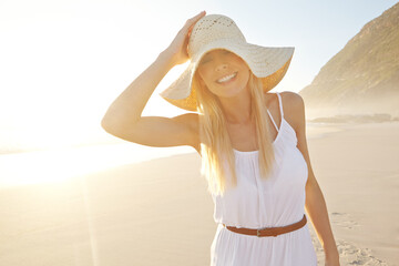Beach, woman and happy for walking, travel and adventure or vacation in nature with hat. Female...