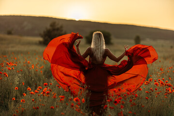 Woman poppy field red dress sunset. Happy woman in a long red dress in a beautiful large poppy...