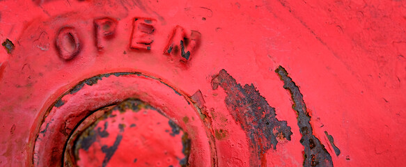 Top of Red Fire Hydrant with Word Open by Bolt Valve
