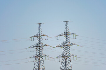 High voltage towers with sky background. Power line support with wires for electricity...