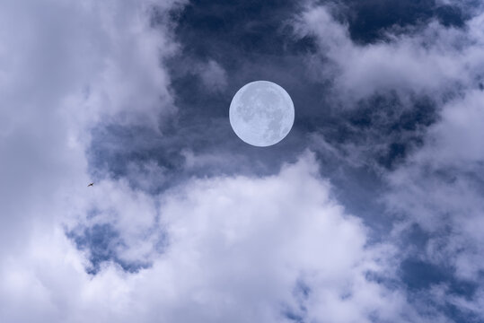 Full moon on the sky with clouds.