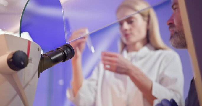 Embryologist performing artificial fertilization of a human egg with a probe in a laboratory. Reproductive science and IVF procedures. Embryologist Fertilizing Human Egg in Laboratory Setting
