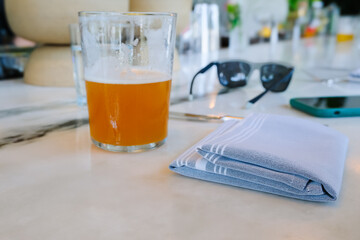 glass of cold ale beer on a bar table, refreshment drinks at summer, relaxing mood