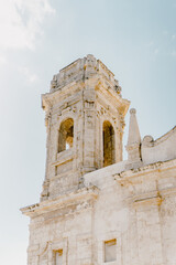Old building with tower in the city centre of Monopoli, Italy
