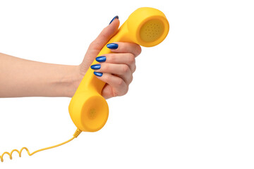 Yellow handset in woman hand isolated on white. Copy space.