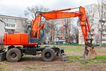 Fototapeta premium A wheeled excavator stands on the construction site.