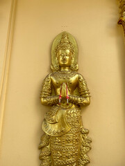 Golden Thai Buddhist Idol statue in Chiang Mai Thailand symbolizing worship at tourist temple.