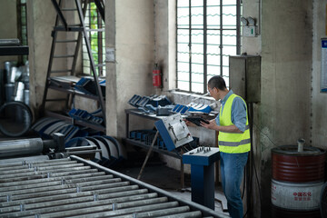 person working with tablet in factory