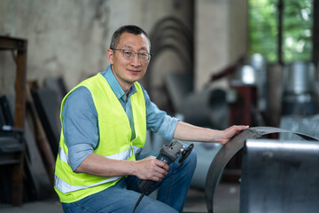 person working with power tool in factory