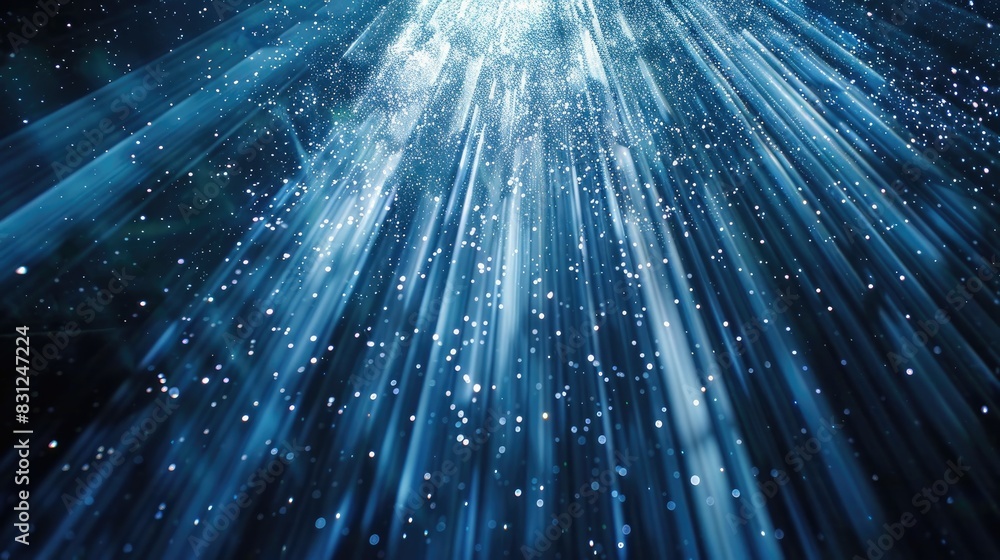 Poster enchanting and continuous loop of blue glitter particles softly descending in delicate light rays