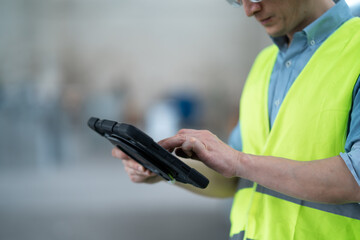person working with tablet in workshop