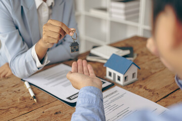 A real estate agent and a customer discuss a contract to buy insurance or a loan on real estate or...