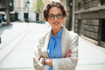 Portrait of a confident professional woman standing in city street
