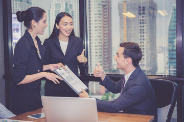 Group of young business team with woman manager standing leader present profit meeting in...